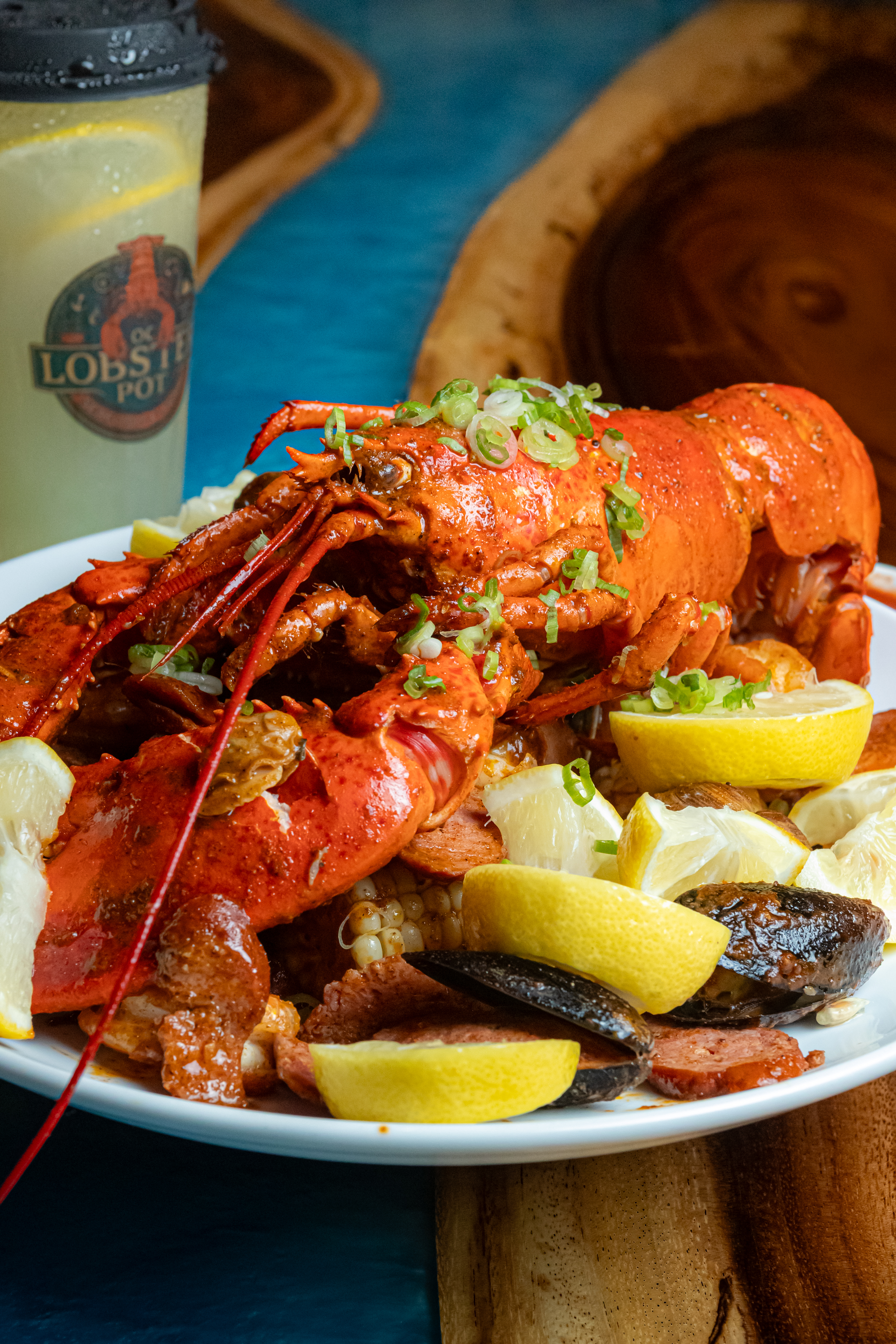 Whole seasoned lobster with corn and lemon